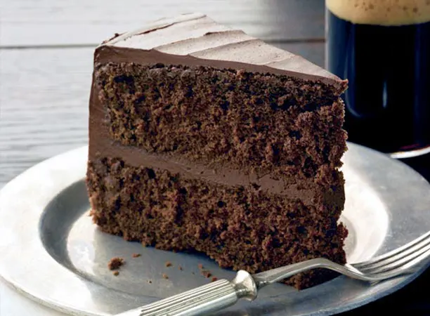 A slice of chocolate cake on top of a white plate.