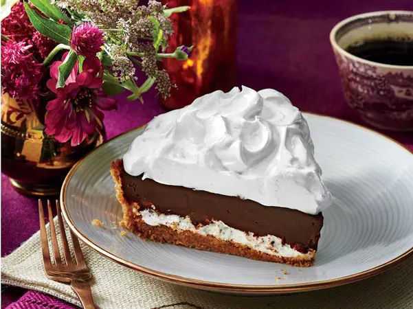 A piece of pie with whipped cream on top.