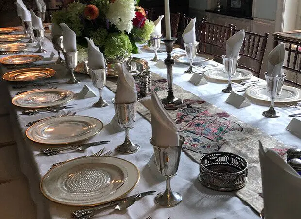 A table set with silverware and plates on it.