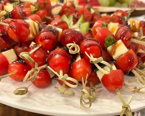 A plate of cherry tomatoes on top of a table.