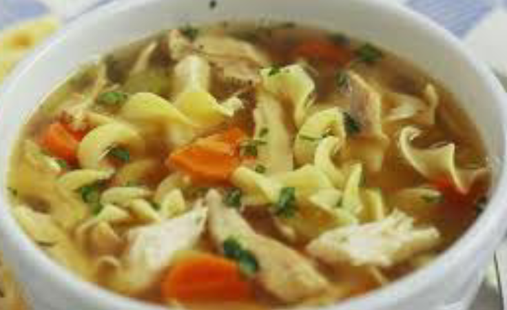 A bowl of soup with noodles and meat.