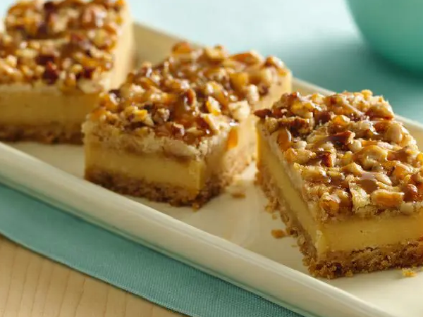 A plate of dessert with nuts on top.