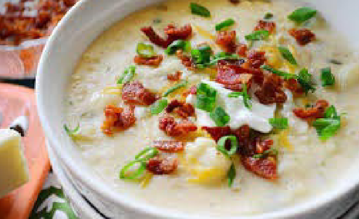 A bowl of food with bacon and cheese.