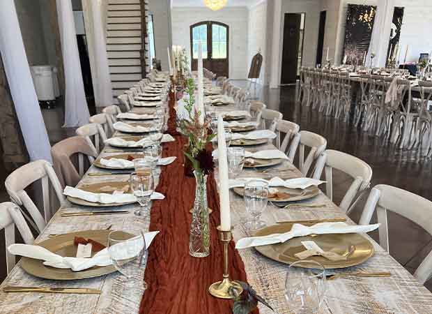 A long table with plates and silverware on it